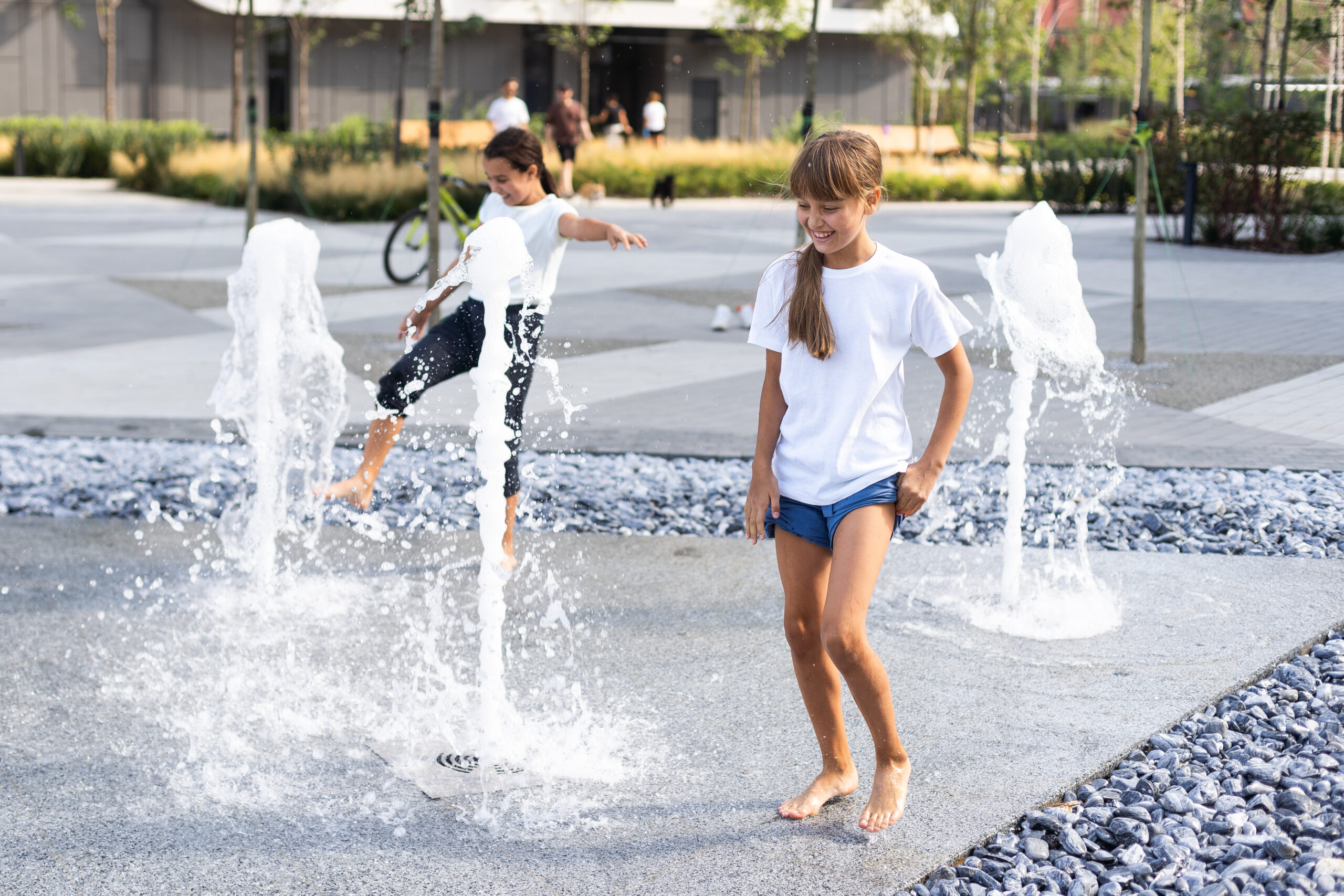 happy kid playing in a fountain with water